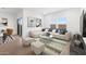 The living room with neutral tones and bright windows creates a cozy atmosphere at 3937 S 233Rd Ln, Buckeye, AZ 85326