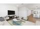 Bright, open living room features modern decor and wood-look flooring at 3937 S 233Rd Ln, Buckeye, AZ 85326