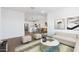 Bright open concept living space with modern kitchen, dining area, and cozy living room at 3937 S 233Rd Ln, Buckeye, AZ 85326