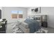 Bright bedroom featuring a large bed with blue accents, a modern art piece, and natural light from two windows at 3937 S 233Rd Ln, Buckeye, AZ 85326