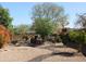 Expansive backyard featuring desert landscaping, a built-in BBQ, and comfortable seating areas at 3957 N 148Th Dr, Goodyear, AZ 85395