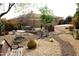 Spacious backyard showcases desert landscaping, comfortable seating, and mature trees at 3957 N 148Th Dr, Goodyear, AZ 85395