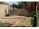Serene backyard features a brick patio and path, colorful flowers, and desert landscaping at 3957 N 148Th Dr, Goodyear, AZ 85395