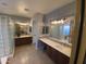 Stylish bathroom boasts dual sinks and a glass block shower, creating a spa-like retreat at 3957 N 148Th Dr, Goodyear, AZ 85395