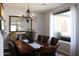 Dining room with wood table, chandelier, and view to outdoor patio at 3957 N 148Th Dr, Goodyear, AZ 85395