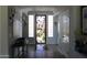 Inviting foyer with decorative lighting, tile flooring, and open doorway with decorative glass at 3957 N 148Th Dr, Goodyear, AZ 85395