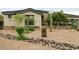 Beautiful Southwestern home featuring native landscaping and desert-friendly plants and rock at 3957 N 148Th Dr, Goodyear, AZ 85395