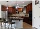 Spacious kitchen with dark wood cabinets, granite countertops, and stainless steel appliances at 3957 N 148Th Dr, Goodyear, AZ 85395