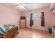 Bedroom with a ceiling fan, tile floor, and window that offers plenty of natural light at 4031 N 81St Ave, Phoenix, AZ 85033