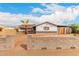 Charming single-story home with a palm tree, block wall, and a covered carport at 4031 N 81St Ave, Phoenix, AZ 85033