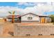Charming single-story home with a palm tree, block wall, and a covered carport at 4031 N 81St Ave, Phoenix, AZ 85033
