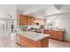 Bright kitchen with wooden cabinets, granite countertops, tile flooring, and stainless steel appliances at 4031 N 81St Ave, Phoenix, AZ 85033
