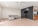 Open-concept living room features neutral tile flooring, ceiling fan, and a cozy gray sofa at 4031 N 81St Ave, Phoenix, AZ 85033