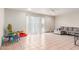 Spacious living area featuring tile floors, ceiling fan, and abundant natural light at 4031 N 81St Ave, Phoenix, AZ 85033