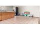 A storage area with tile flooring features boxes, water bottles, and a stainless steel refrigerator at 4031 N 81St Ave, Phoenix, AZ 85033