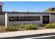 Elegant community sign welcomes residents to San Tan Groves, set against a backdrop of lush landscaping and clear blue skies at 4154 W Jeanette Ln, San Tan Valley, AZ 85144