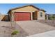 Charming single-story home boasts a brick driveway, a two-car garage, and low-maintenance desert landscaping at 4154 W Jeanette Ln, San Tan Valley, AZ 85144