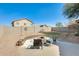 Private backyard featuring a built-in fire pit, patio area, and seating at 4332 W Carson Rd, Laveen, AZ 85339