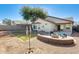 Spacious backyard featuring a rock landscape, a built-in fire pit, and a small grassy area at 4332 W Carson Rd, Laveen, AZ 85339