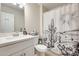 Bright bathroom with a white vanity, neutral walls, and unique cactus themed shower curtain at 4332 W Carson Rd, Laveen, AZ 85339