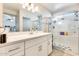Bathroom features white cabinets, shower stall, and a large mirror at 4332 W Carson Rd, Laveen, AZ 85339