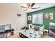 Fun bedroom with green accent wall and dinosaur themed decor at 4332 W Carson Rd, Laveen, AZ 85339