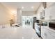 Modern kitchen with stainless steel appliances, quartz countertops, and a view into the dining area at 4332 W Carson Rd, Laveen, AZ 85339