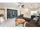 Open-concept living room featuring tile flooring, a ceiling fan, and a modern accent wall at 4332 W Carson Rd, Laveen, AZ 85339