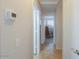 Hallway leading to a room with a rocking chair at 43409 W Sagebrush Trl, Maricopa, AZ 85138