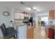 Open floor plan with breakfast bar in kitchen with modern appliances at 43409 W Sagebrush Trl, Maricopa, AZ 85138