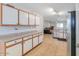 Bright kitchen featuring tile floors, stainless steel dishwasher and refrigerator, and ample counter space at 43409 W Sagebrush Trl, Maricopa, AZ 85138