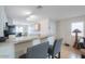 Open floor plan with breakfast bar in kitchen with modern appliances at 43409 W Sagebrush Trl, Maricopa, AZ 85138