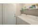 Convenient laundry room featuring modern washer and dryer, plus ample shelving for storage at 43409 W Sagebrush Trl, Maricopa, AZ 85138