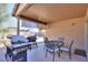 Relaxing covered patio with seating area, ideal for enjoying outdoor meals and gatherings at 43409 W Sagebrush Trl, Maricopa, AZ 85138