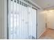 Bright sliding glass door with vertical blinds, providing access to the outdoor area and natural light at 43409 W Sagebrush Trl, Maricopa, AZ 85138