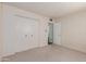 Bedroom features a spacious closet with bifold doors and neutral carpeted floors at 4510 W Keim Dr, Glendale, AZ 85301