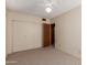 This bedroom includes a spacious closet with bifold doors and a ceiling fan for comfort at 4510 W Keim Dr, Glendale, AZ 85301
