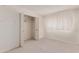 Bedroom features a closet with bifold doors and a window offering natural light at 4510 W Keim Dr, Glendale, AZ 85301