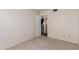 View of a bedroom with an open door, neutral carpeting, and electrical outlets at 4510 W Keim Dr, Glendale, AZ 85301