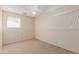 Bedroom featuring two windows with white curtains, and neutral carpeted floors at 4510 W Keim Dr, Glendale, AZ 85301