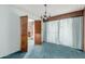 Traditional dining room with blue carpet, chandelier, and shutter doors at 4510 W Keim Dr, Glendale, AZ 85301