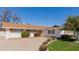 Charming single-story home with white brick and shutters, manicured lawn, and orange tree at 4510 W Keim Dr, Glendale, AZ 85301