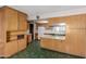 Bright kitchen with plentiful wood cabinetry, green tile floor, and a functional layout at 4510 W Keim Dr, Glendale, AZ 85301