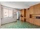 Functional kitchen area with built-in wood cabinets and adjoining light-filled living space at 4510 W Keim Dr, Glendale, AZ 85301