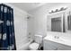 Bathroom featuring shower-tub combination with blue patterned curtain, toilet, and white vanity with mirror and lighting at 461 W Holmes Ave # 383, Mesa, AZ 85210