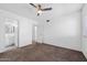This bedroom features a ceiling fan, neutral carpet, and an en suite bathroom, offering comfort and convenience at 461 W Holmes Ave # 383, Mesa, AZ 85210