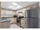 Functional kitchen with stainless steel appliances, ample cabinet storage, and natural lighting at 461 W Holmes Ave # 383, Mesa, AZ 85210