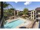 Aerial view of a pool with lounge seating surrounded by well-maintained landscaping and community buildings at 461 W Holmes Ave # 383, Mesa, AZ 85210