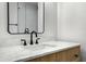 Bathroom with marble counters, wood cabinets, and modern fixtures; plus a glass enclosed shower at 4955 E Indian School Rd # 5, Phoenix, AZ 85018