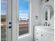 Stylish bathroom featuring modern vanity, round mirror, and a view from the window at 4955 E Indian School Rd # 5, Phoenix, AZ 85018